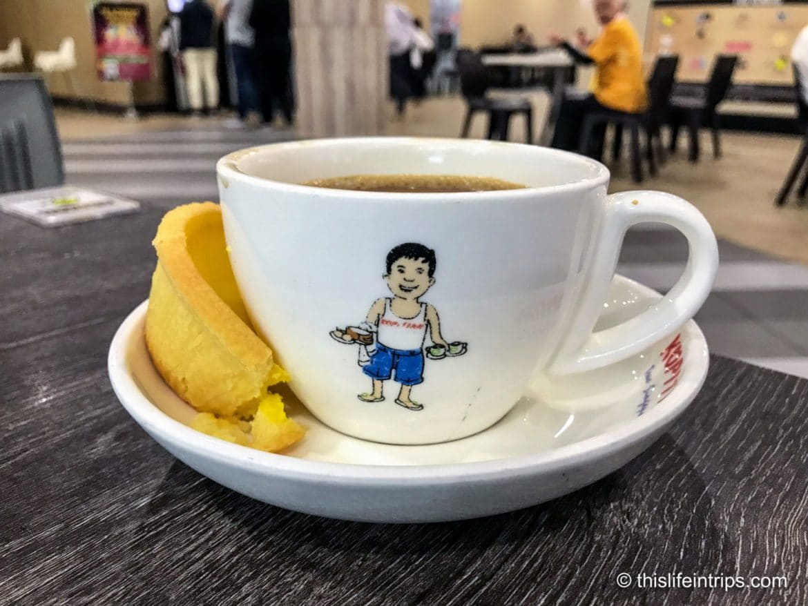 Enjoying sips of Singaporean Coffee