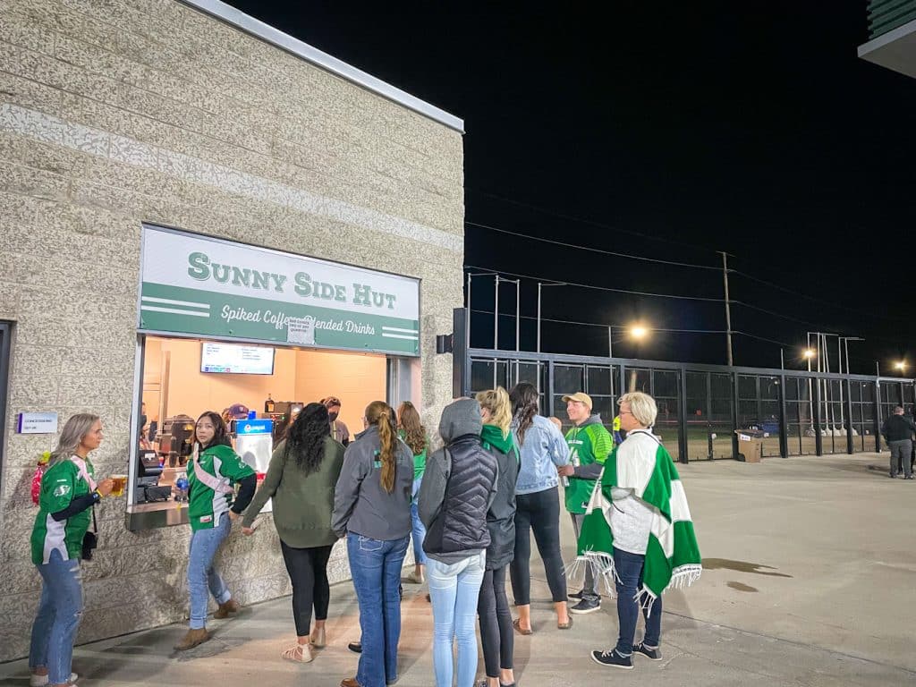 Spectator grabbing some foods and drinks at Mosaic Stadium