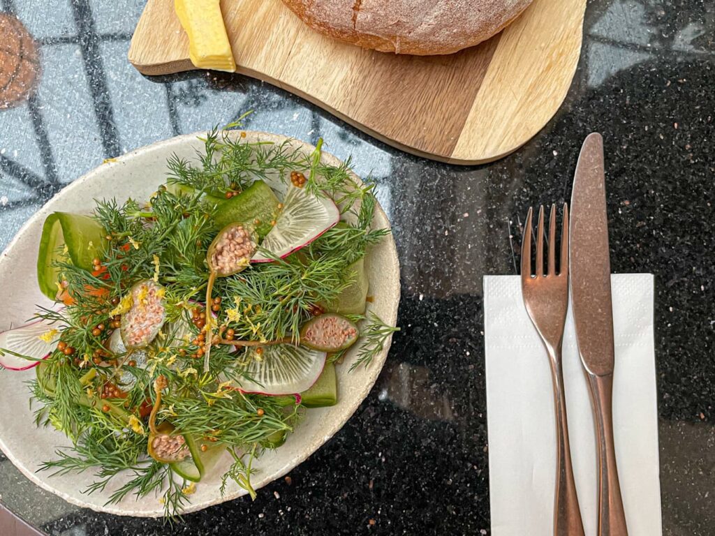 Merchant Hotel Buku restaurant salad and bread