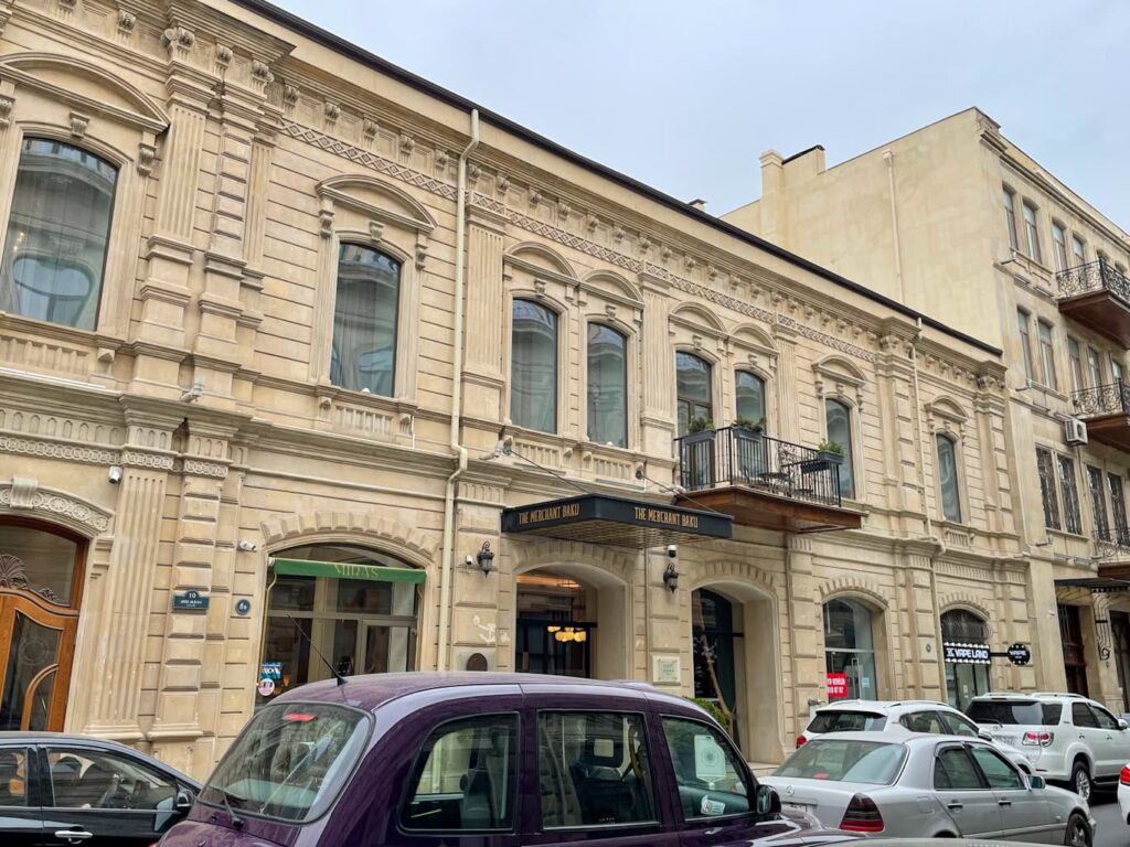 Merchant Hotel Buku exterior with cars out front