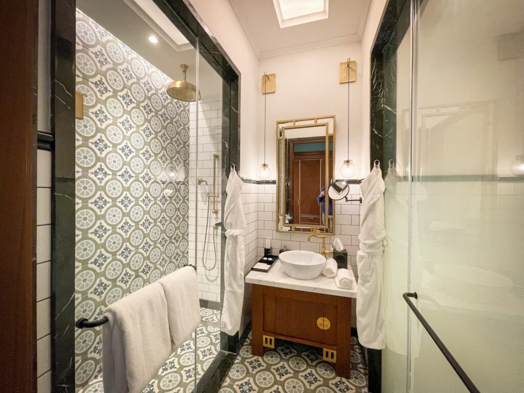Merchant Hotel Buku deluxe room bathroom with beautiful decorative tile work