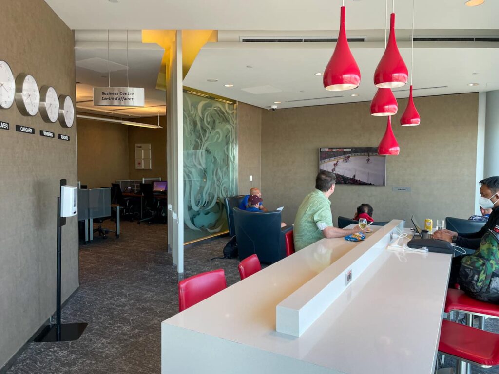 Workspace table with power outlets on top - Winnipeg Maple Leaf lounge