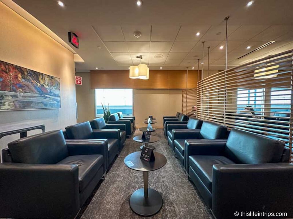 Edmonton Plaza Premium lounge leather seats and small tables in a row