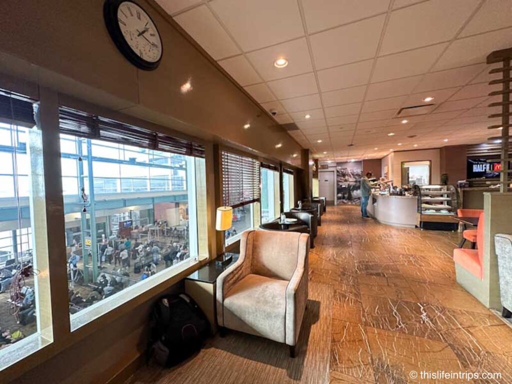 Edmonton Plaza Premium lounge seat along the window overlooking busy gate below