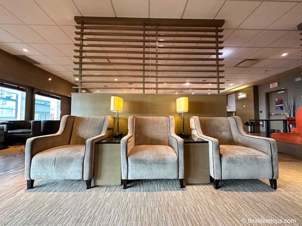 3 plush seats at the Entrance to the Edmonton Plaza Premium lounge