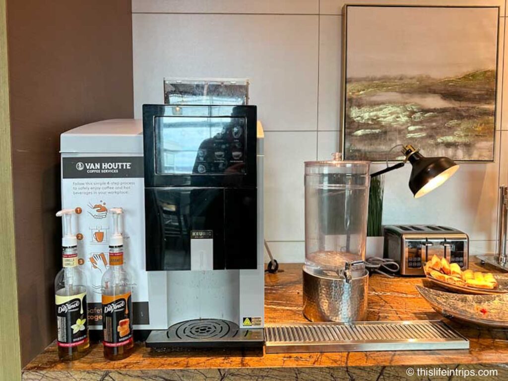 Van Houtte Coffee machine next to a water jug that is low on water.