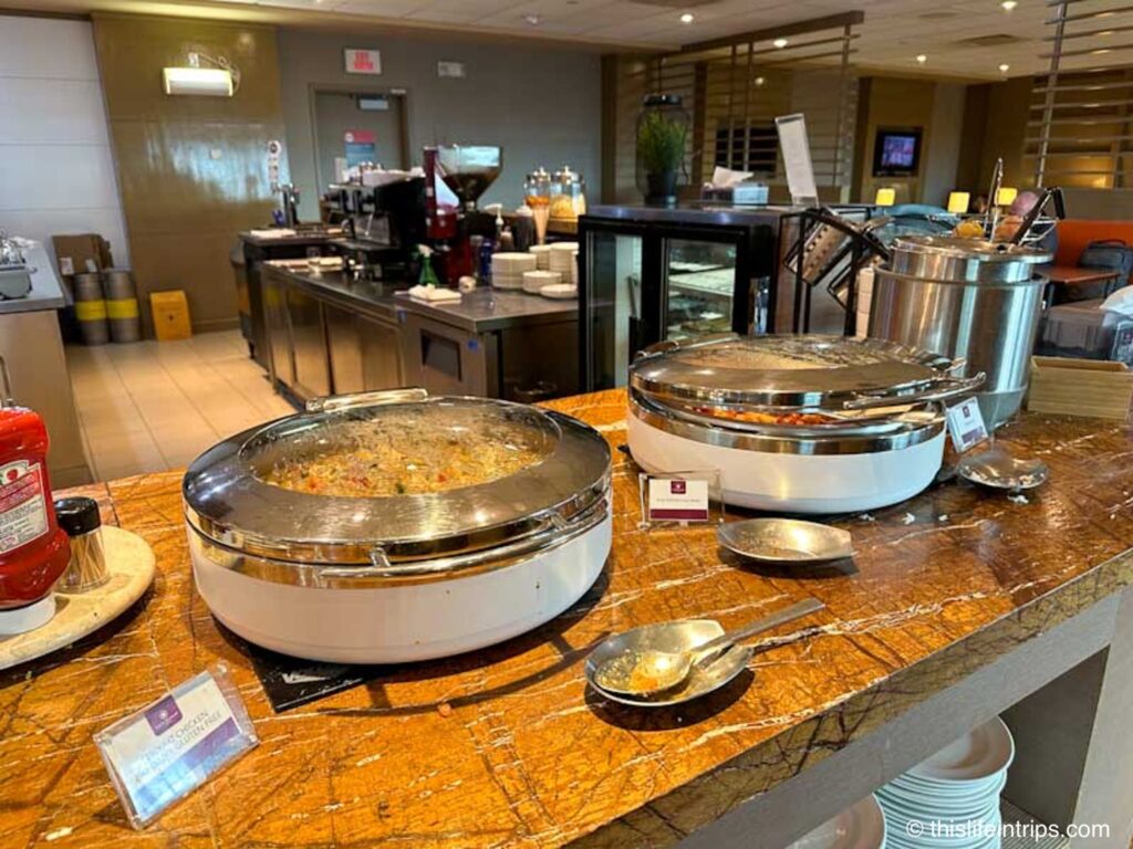 Edmonton Plaza Premium lounge hot serving dishes in front of the bar