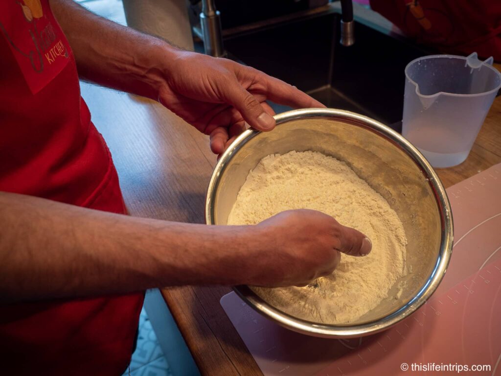 Nana's kitchen - preparing dough hand in bowl of flour mixing