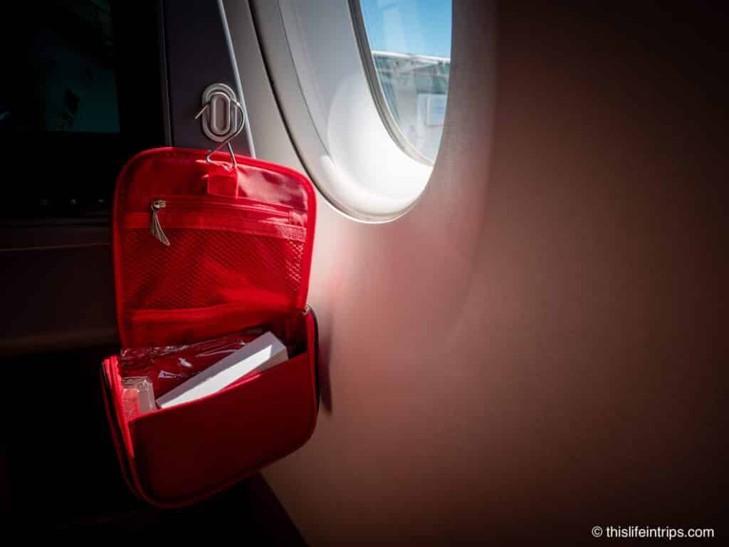 Ethiopian Airlines 787-9 Business Class amenities kit hanging from hook next to window.