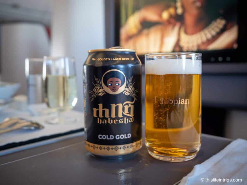 beer in a glass next to can on a Ethiopian Airlines 787-9 Business Class flight