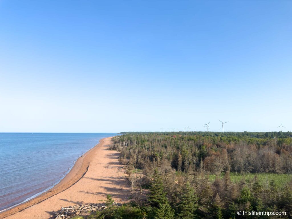Daytime view at the top of the West Point Lighthouse with windmills in the distance