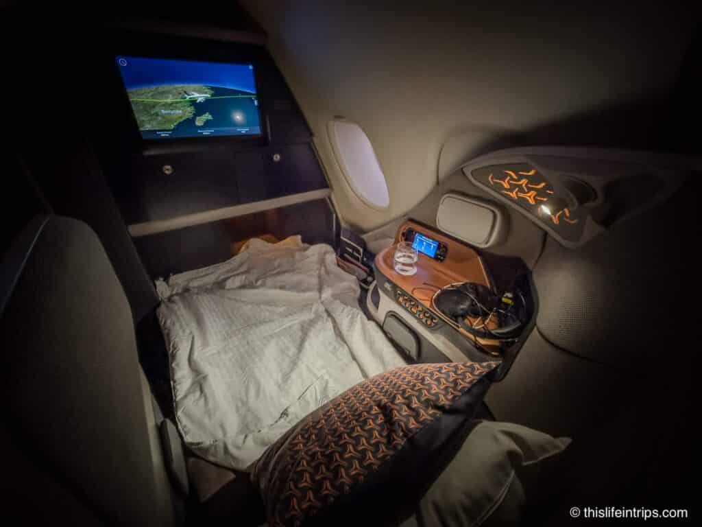 Singapore Airlines a380 Business Class seat laid flat with bedding