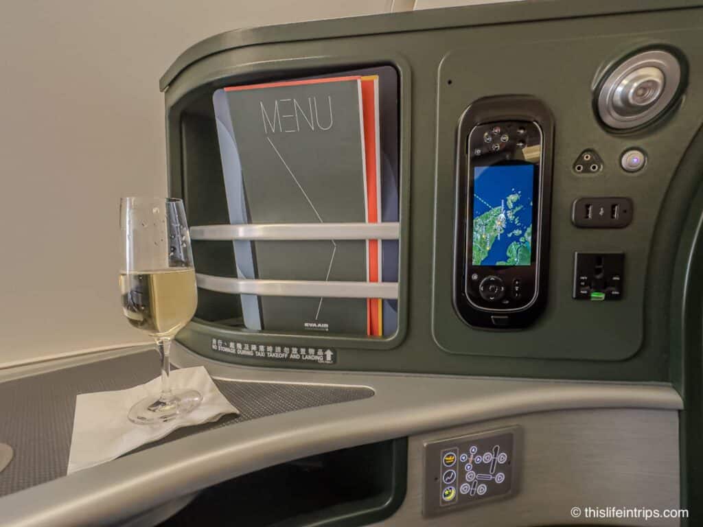 Eva Air Boeing 777 300er business class seat storage with glass of champagne