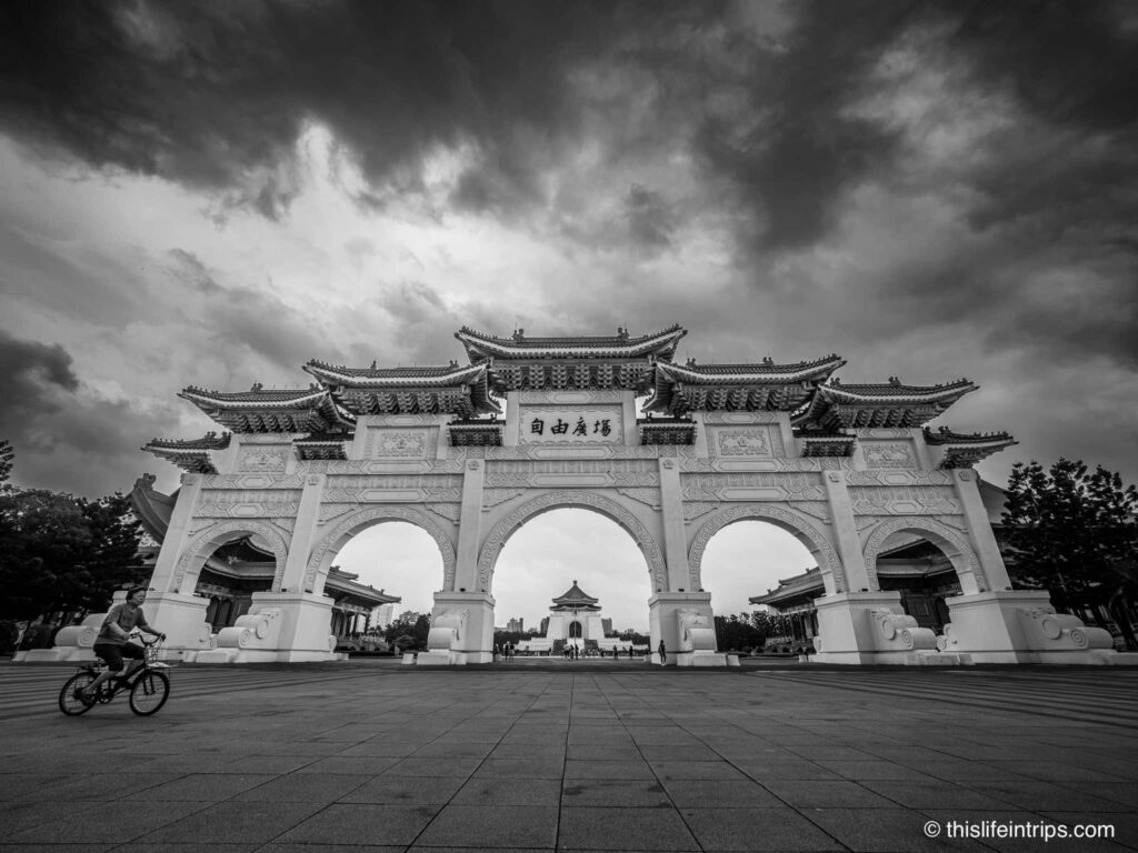 Women biking in front of the Daxiao Gate in Taipei