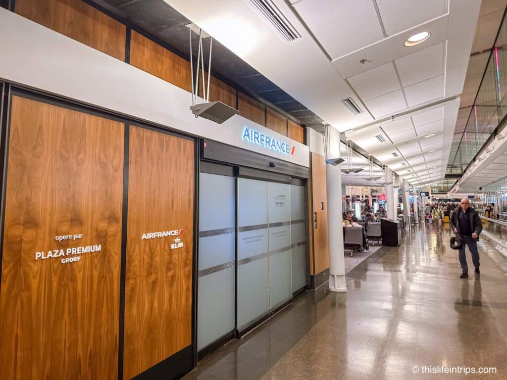 Stopping at the Air France lounge entrance at Montreal airport before taking Flights from Montreal to Paris