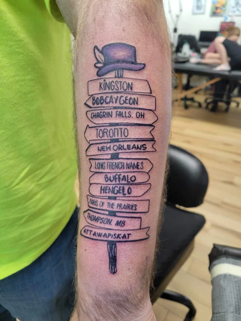 Man arm tattoo depicting towns and places referenced in the Hip catalog.