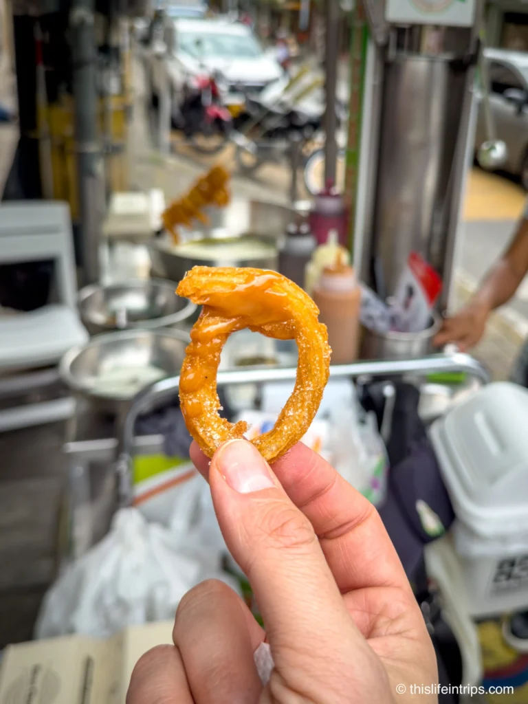 Hand holding up a Churro in Medellin