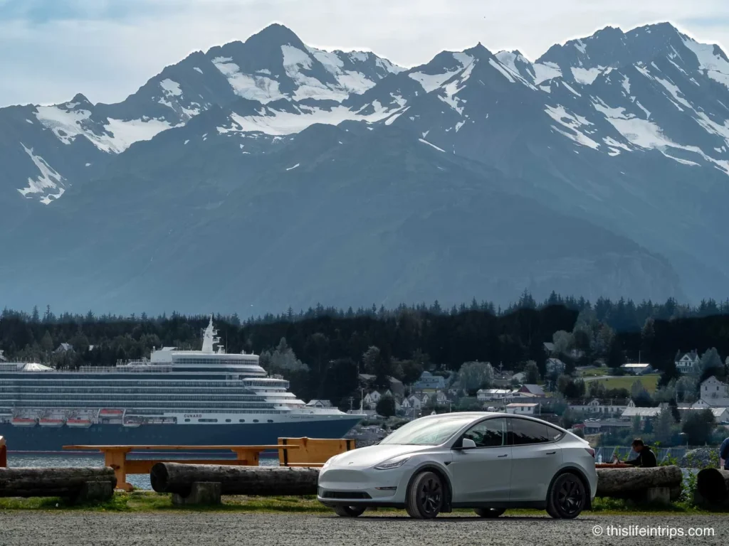 Tesla Model Y in front of Haines Alaska cruise port with ship in background