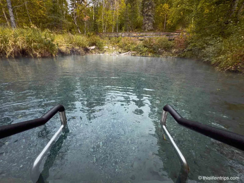 steps into the Liard River Hot Springs