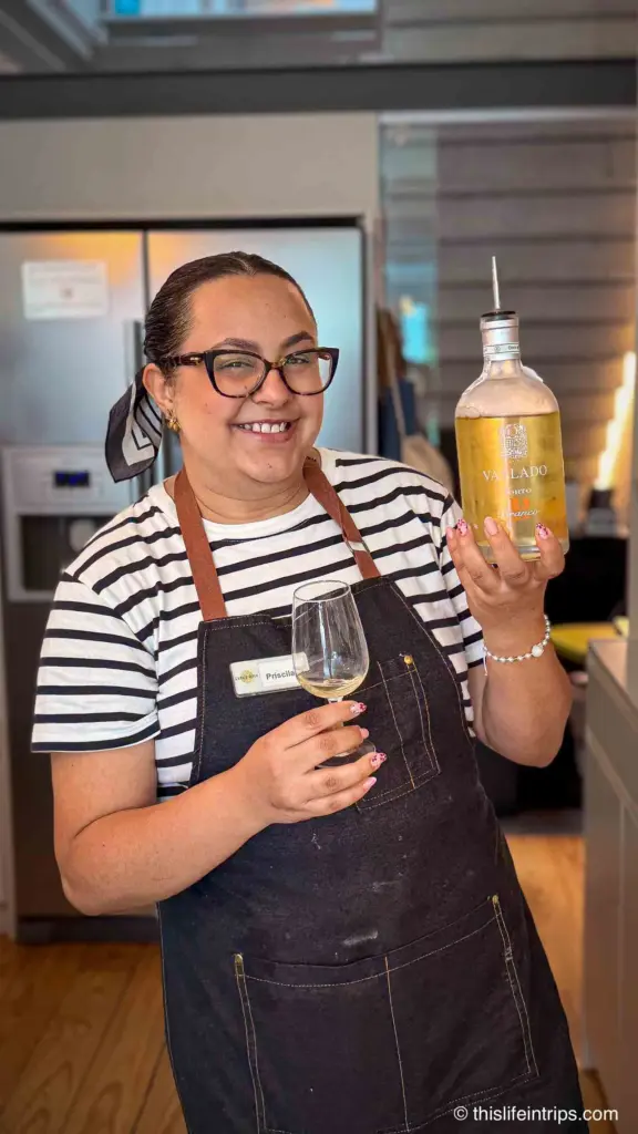 Canto Cooking chef holding a bottle of port