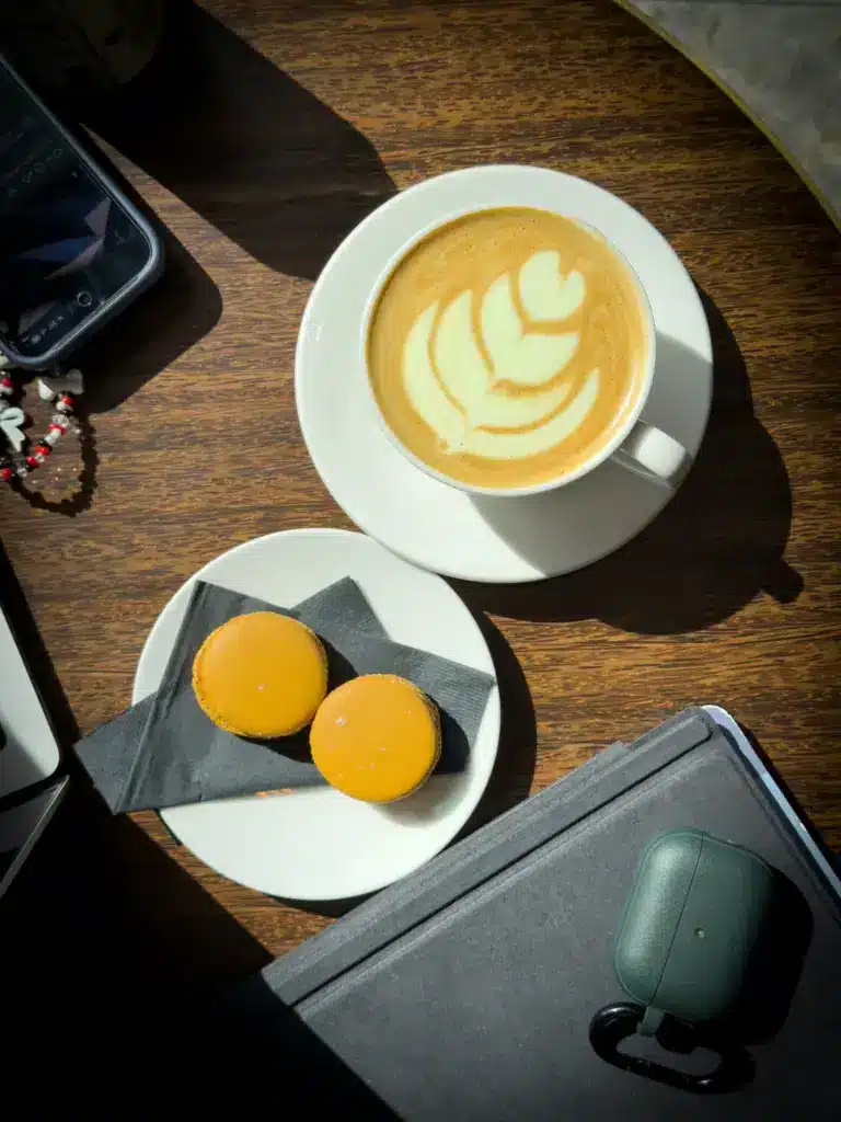 photo of latte and macarons while looking for the best coffee in Copenhagen